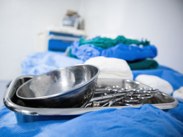 Various surgical instruments and equipment on a table in a healthcare setting.