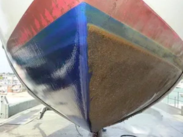 Shows a boat with half coated in Sea-Slide anti-fouling boat hull coating and one half with no coating. 