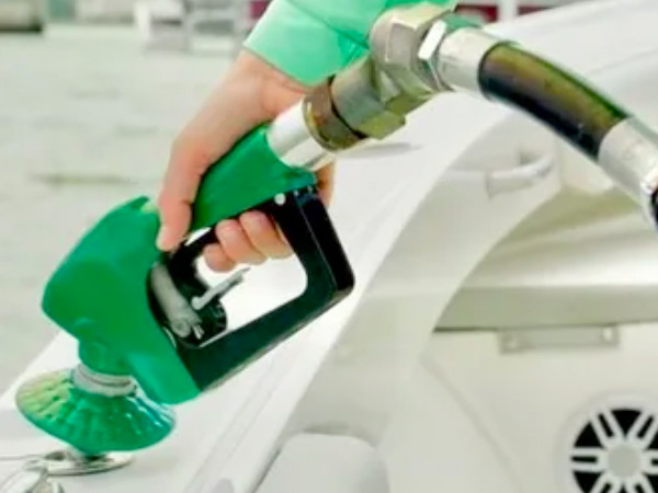 Marine grade gas being added to a boat.